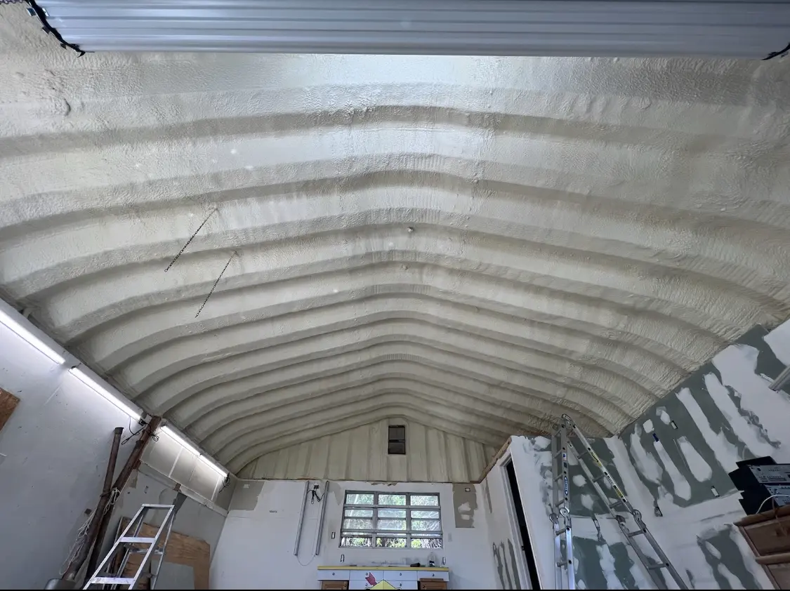 Spray polyurethane foam applied to the underside of a metal roof deck in Eidson Road
